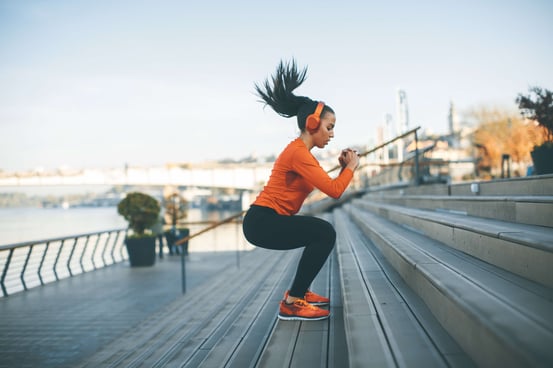 woman exercising while listening to music on fitness app